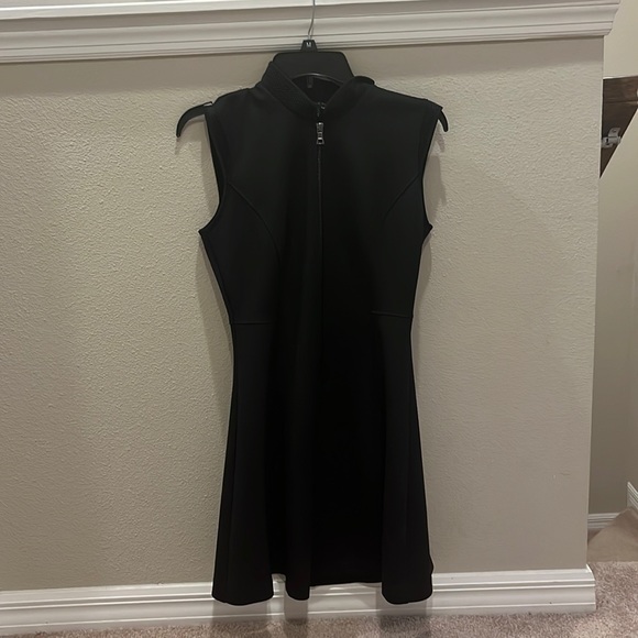 This is a black dress with a zipper and collar. It is an athletic material. - Picture 1 of 3